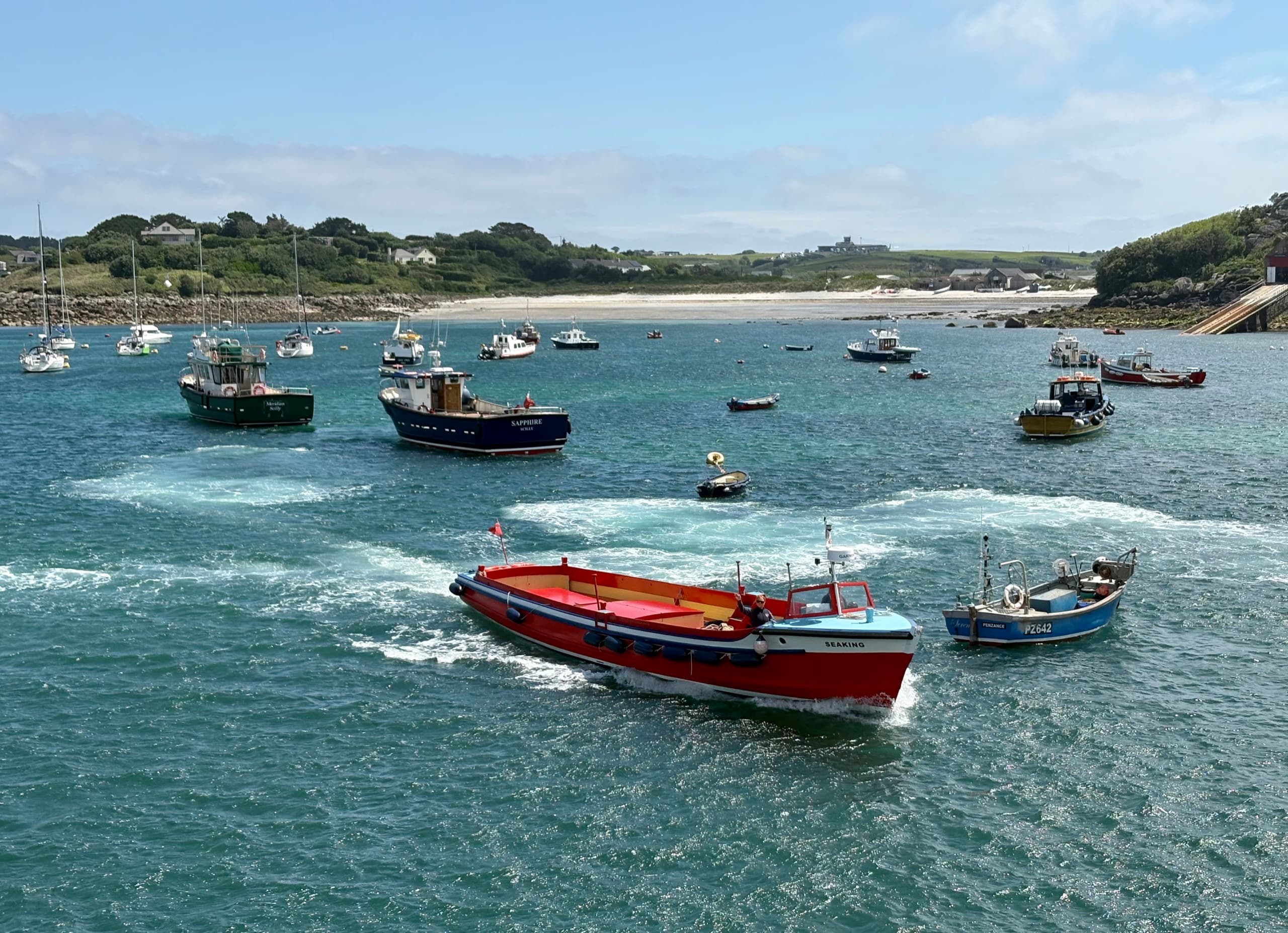 Colourful passenger and fishing boats in a harbour on the Isles of Scilly