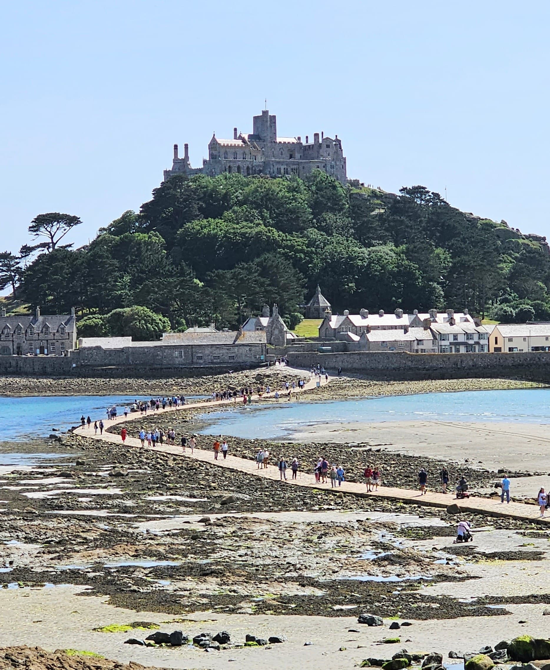 Visitors crossing the causeway to St Michael's Mount at low tide