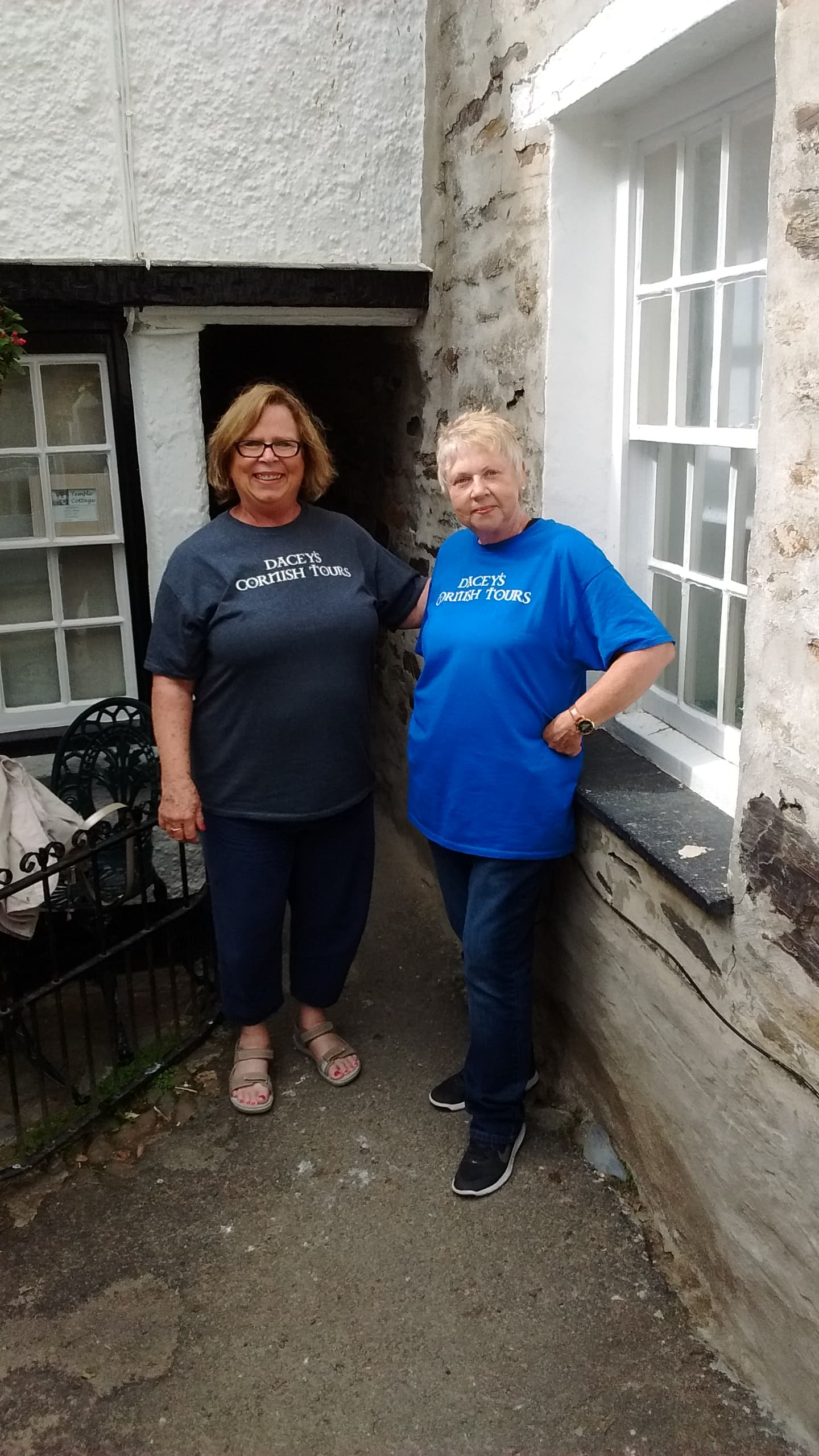 Ginger & Charlotte, walking through Squeeze belly alley, Port Isaac Cornwall UK