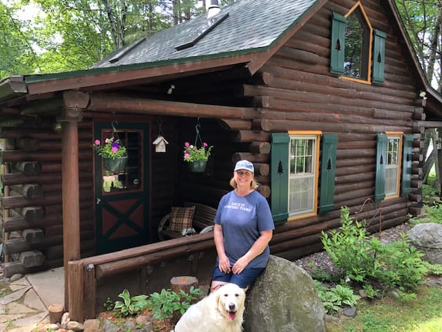 Karen, standing outside her cabin Wisconsin. USA