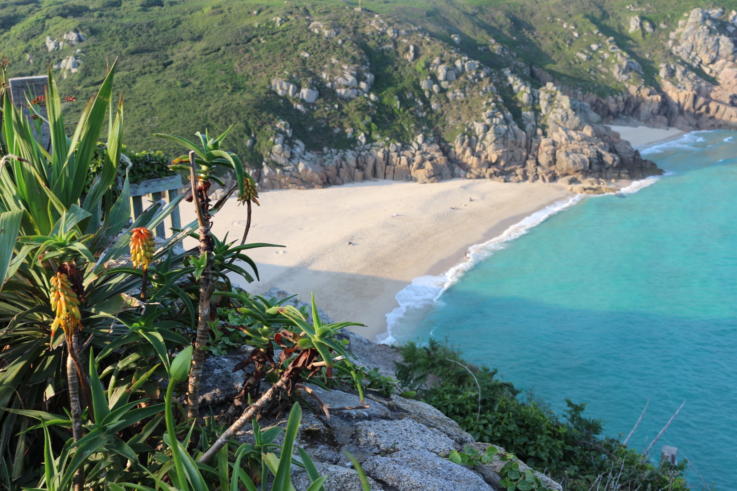 Turquoise water and golden sand at Porthcurno below the Minack Theatre