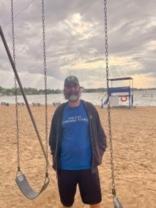 Chris wearing is Dacey's shirt on the beach Michigan